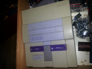 Super Nintendo, has a power supply issue.  Complete with 1 controller and some aladdin game